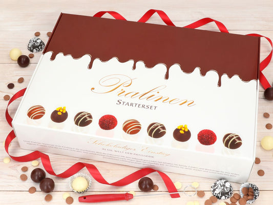 Pralinen Starterset Inhalt: Hohlkörper aus Schokolade, Kuvertüre, Aromapaste, Spritztüten, Pralinengabel und Dekoration für selbstgemachte Pralinen.